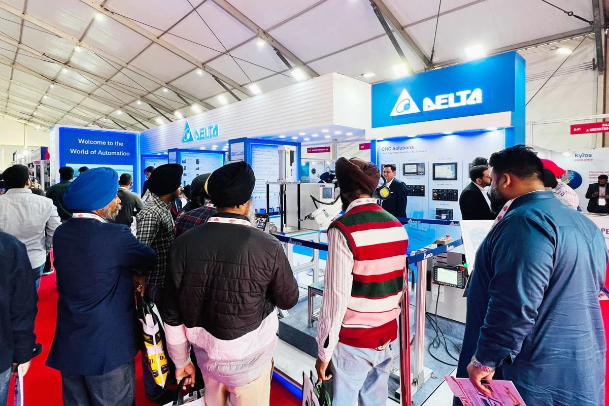 Visitor looking at robotic arm in Delta's booth at MachAuto2025